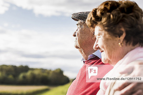 Senior couple embracing in rural landscape