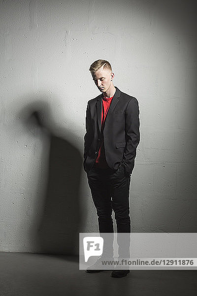 Young man wearing black suit and red t-shirt