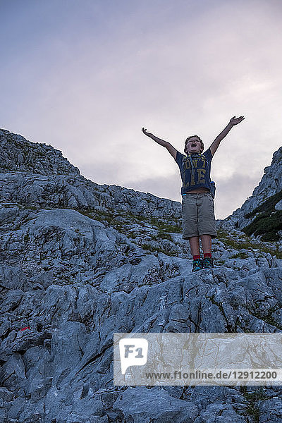 Austria  Salzburg State  Loferer Steinberge  boy on a hiking trip cheering in the mountains