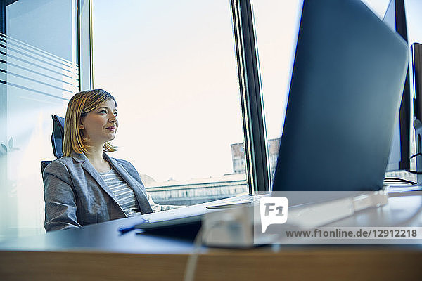 Businesswoman sitting at desk in office