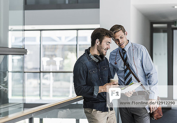 Two colleagues talking on office floor