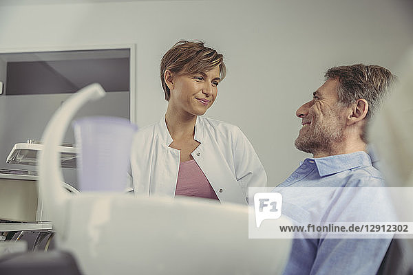 Female dentist talking to her patient before treatment