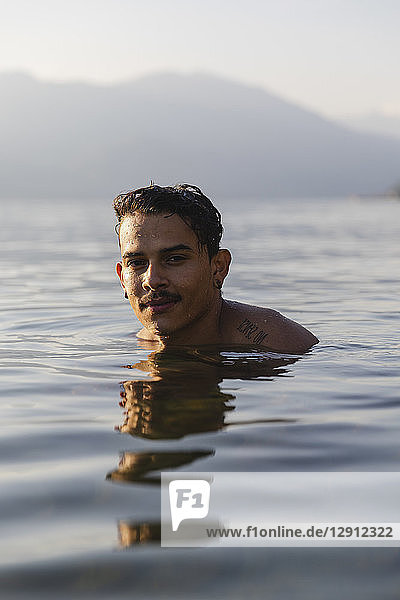 Portrait of smiling young man in a lake