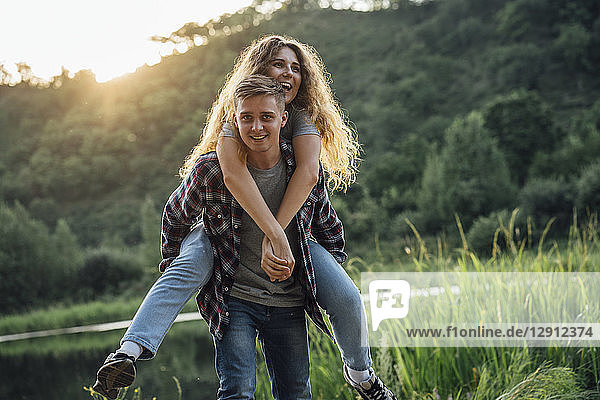 Romantic couple spending time in nature  embracing at sunset