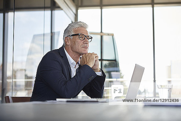 Businessman sitting in office  thinking