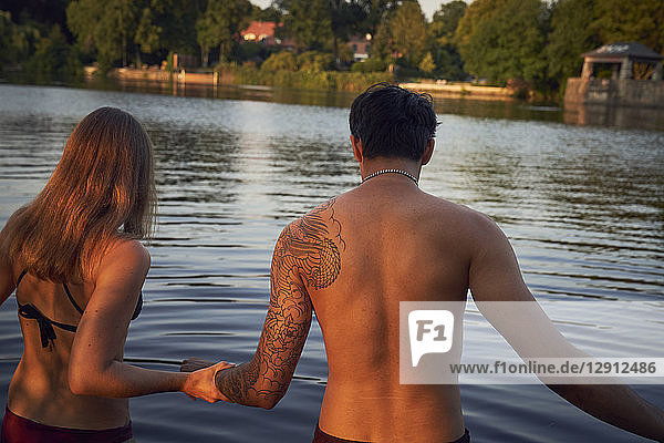 Young couple going into a lake  bathing