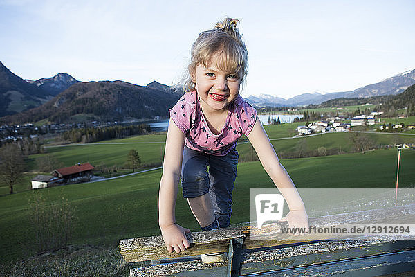 Austria  Tyrol  Walchsee  happy girl on a bench
