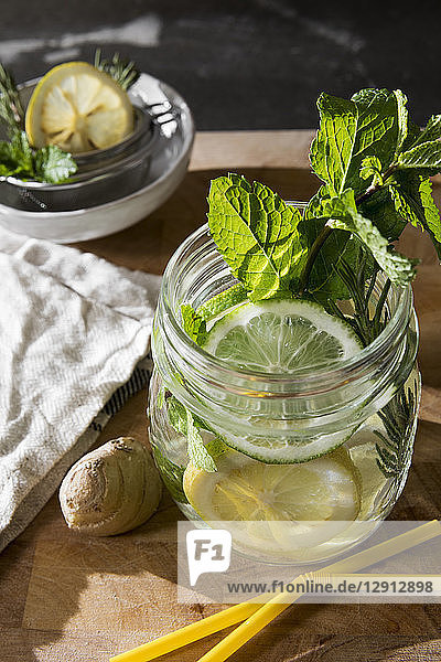 Glass of detox water with mint  ginger  rosmary and limes