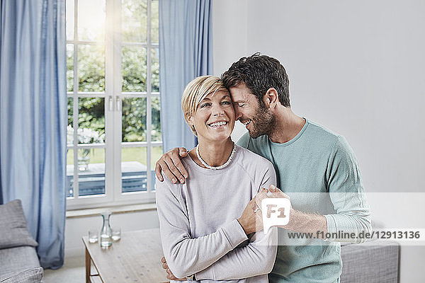 Happy affectionate couple embracing at home