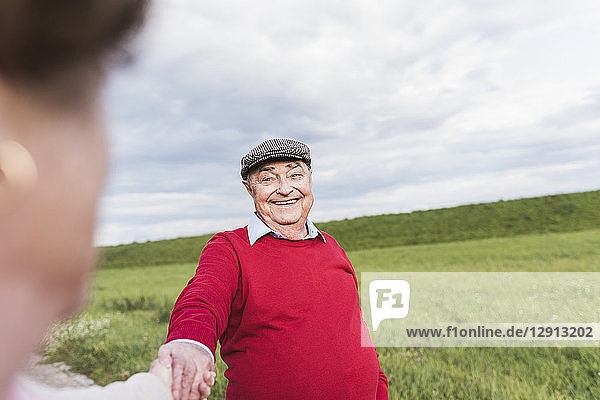 Happy senior man smiling at wife in rural landscape
