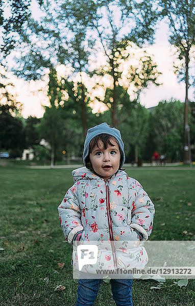 Portrait of fashionable little girl in autumnal park