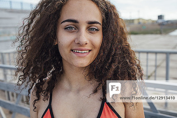 Portrait of smiling brunette young woman outdoors