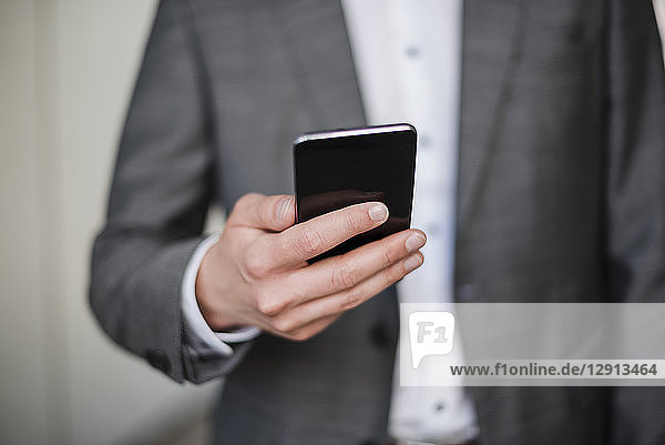 Close-up of businessman holding cell phone