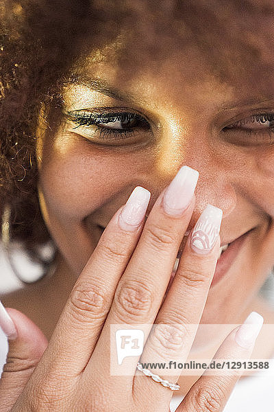 Portrait of laughing young woman with artificial nails