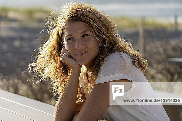 Portrait of a beautiful woman at the beach in summer