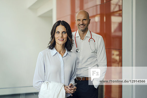 Friendly doctors standing in hospital  smiling