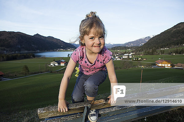 Austria  Tyrol  Walchsee  happy girl on a bench