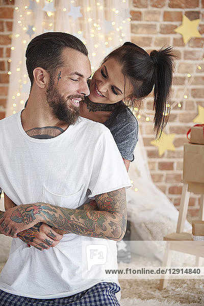 Happy young couple at home at Christmas time
