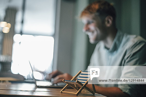 Young man booking vacation  using laptop