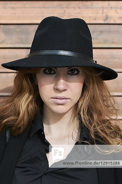 Mid adult woman wearing black hat