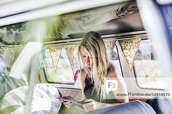 Woman using tablet inside a van