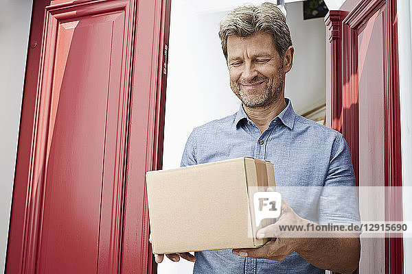 Mature man receiving a package at his door