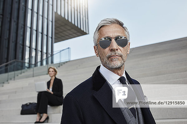 Portrait of mature businessman wearing mirrored sunglasses