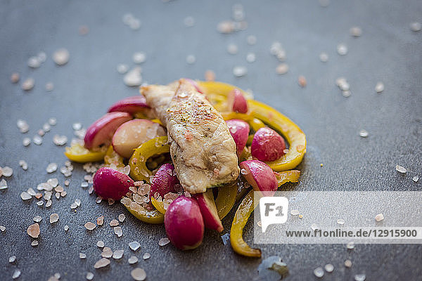 Grilled chicken with yellow bell peppers and red radishes