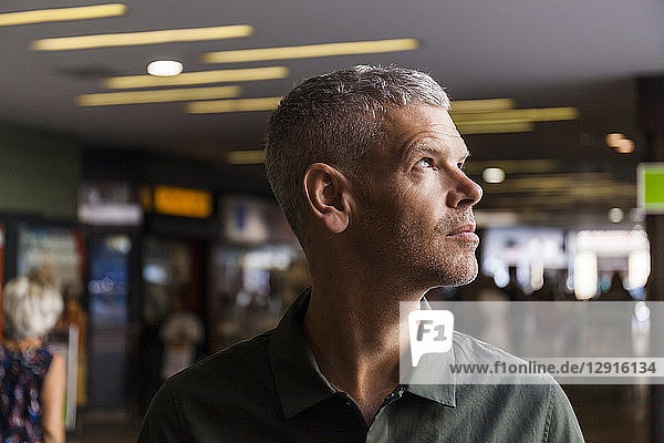 Portrait of a mature man in the city looking sideways