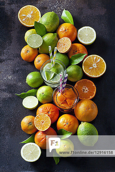 Limes, lemons, oranges and tangerines om dark background