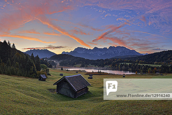 Germany  Bavaria  Werdenfelser Land  lake Geroldsee with hay barn at sunset  in background the Karwendel mountains at sunrise