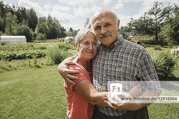 Portrait of senior couple embracing each other in the garden