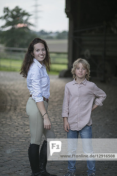 Portrait of young woman and boy on a farm