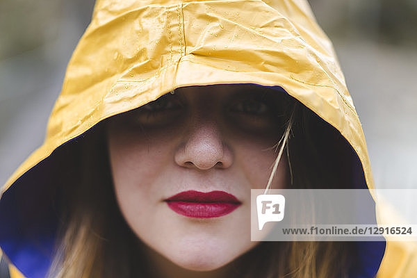 Portrait of woman wearing yellow hood of rainjacket