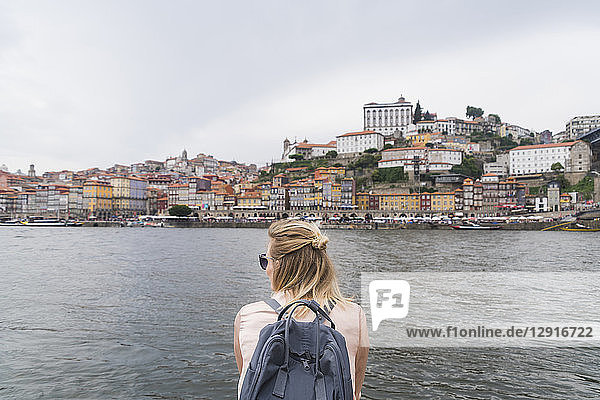 Portugal  Porto  back view of woman with backpack in front of douro River