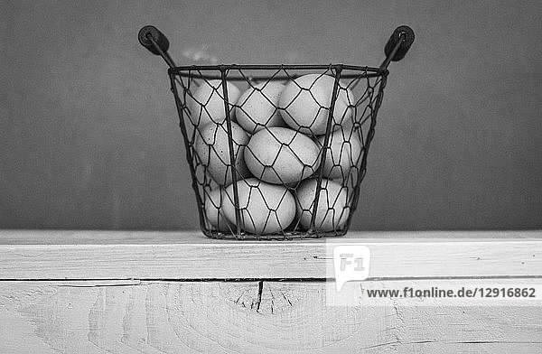 Wire basket of white eggs
