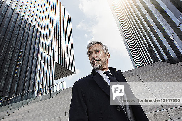 Portrait of fashionable businessman in front of modern architecture