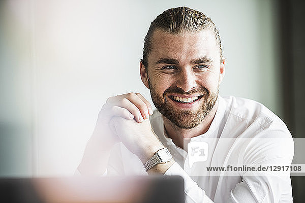 Portrait of smiling young businessman in office