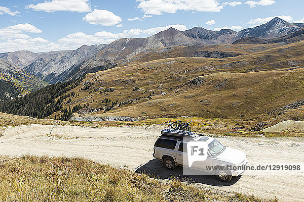 4x4 car driving on dirt road in natural scenery with mountains at Alpine Loop  Colorado  USA