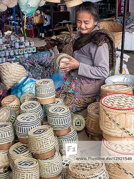 Woman selling baskets for sticky rice in central outdoor market  Luang Prabang  Laos  Indochina  Southeast Asia  Asia
