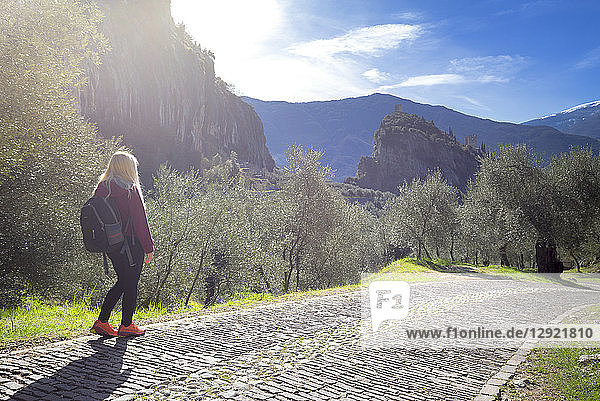 A young tourist walks on the Via Crucis  Arco di Trento  Trento province  Trentino-Alto Adige  Italy