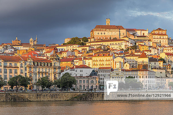 View from Mondego River to the old town with the university on top of the hill at sunset  Coimbra  Portugal  Europe