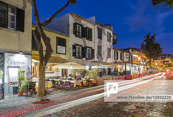 Blick auf Cafés und Autostraßenbeleuchtung in der Altstadt in der Abenddämmerung  Funchal  Madeira  Portugal