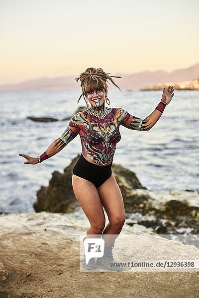Dancing woman with body painting on the beach  topless  Hersonissos  Crete  Greece