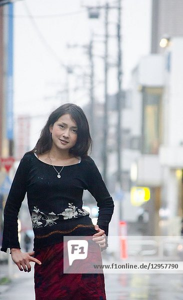 Japanese Girl poses on the street in Fussa  Japan. Fussa is a city located in Tokyo.