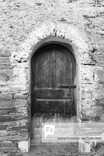Aran valley landscape Medieval chapel in Arres de Sus village Lleida Catalunya Spain. Door detail in black and white.