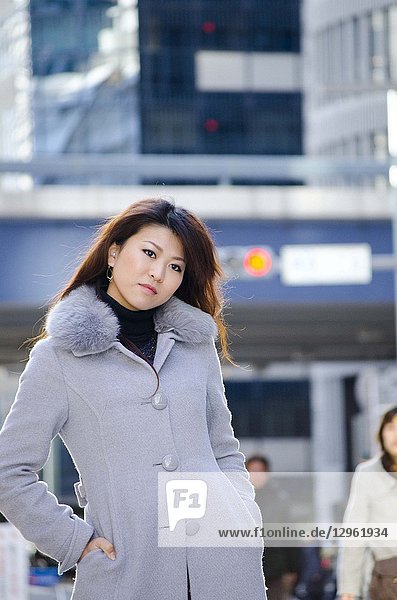 Japanese Girl poses on the street in Ginza  Japan. Ginza is a shopping city located in Tokyo.