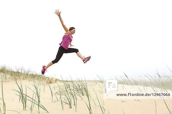 Young woman on the beach. Jump