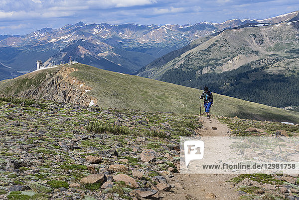 Woman hiking trail on Berthoud Pass Trail in Colorado