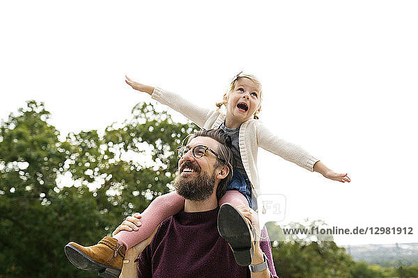 Father giving daughter piggyback ride
